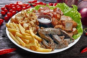 Snacks with fries, crackers, meat, pork, sausage photo