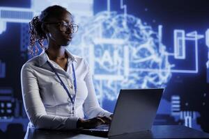 BIPOC woman developing artificial intelligence neural networks nodes modeled after human brain. Tech support setting up AI machine learning accurately making predictions using data photo