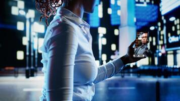 Woman talking with friend in online videocall using smartphone while strolling around empty city boulevards at night. Person showing companion surroundings in urban environment photo