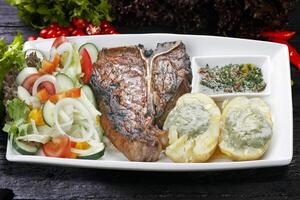 t bone steak with potato salad photo