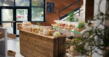 Bulk products in reusable glass jars used by zero waste small business store to lower climate impact and support sustainable lifestyle. Local supermarket with pantry supplies. photo