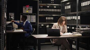 Caucasian policewoman entering office space with documents, evidence, and files setting up for research and observation. Female private investigator expertly analyzes confidential records on laptop. photo