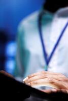 Close up shot of engineer doing maintenance in blurry background data center providing vast computing resources and storage, enabling artificial intelligence to process massive datasets for training photo