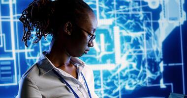 Portrait of smiling african american developer programming scripts on laptop, employing AI machine learning, manipulating lines of code for artificial intelligence applications computing photo