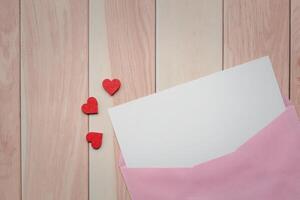 Valentine's day love letter on wooden background with copy space photo