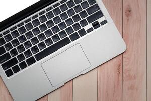 Laptop computer on wooden table. Top view with copy space. photo