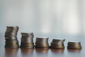 Coins stacked on each other in a row, business and finance concept photo