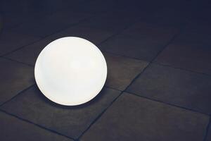 Magic glowing white ball on stone tile floor. High quality photo