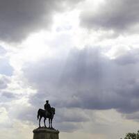 Silhouette of the monument of Ataturk in Ankara and sunrays in the clouds photo
