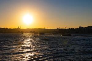 Istanbul view at sunset from a ferry. Visit Istanbul concept photo