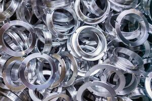 a batch of machined shiny aluminium parts with selective focus photo