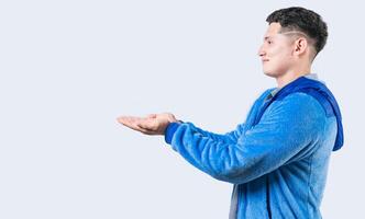 Smiling person showing something with palms together. Guy showing something with palms together isolated photo