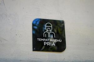 a sign for men's ablutions at a prayer room photo