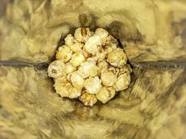 Cheese flavored popcorn in plastic packaging photo