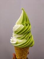 a matcha and vanilla ice cream cone photo