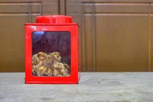 a classic red iron jar with glass showing the snacks inside photo