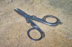 a small metal folding pair of scissors photo