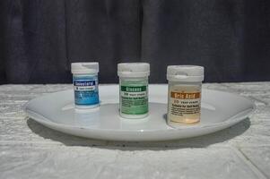 one packet of uric acid, cholesterol, glucose test strips on a plate photo