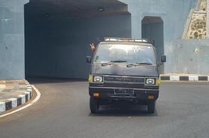 a pickup truck passing out of the underpass tunnel photo