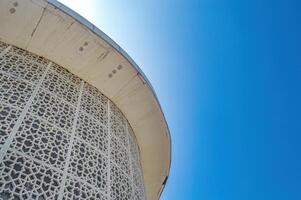 modern minimalist mosque with bright blue sky background photo