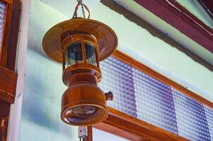 hanging antique wooden Petromax lamp decoration photo