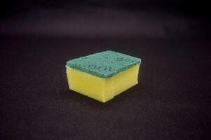 a dishwashing sponge isolated on black background photo