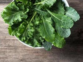 colorful vegetable salad on wood table kale and sunflower sprout photo