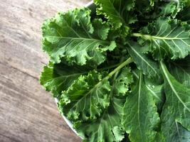 colorful vegetable salad on wood table kale and sunflower sprout photo