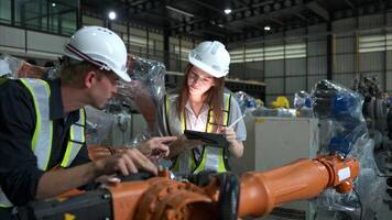 Both of engineers working together in a robotic arm factory, Robotic arm industry and engineering concept. photo