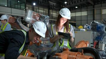 Both of engineers working together in a robotic arm factory, Robotic arm industry and engineering concept. photo