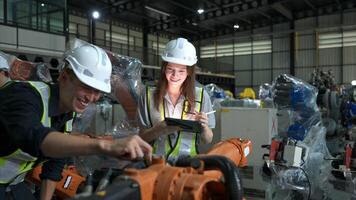 Both of engineers working together in a robotic arm factory, Robotic arm industry and engineering concept. photo