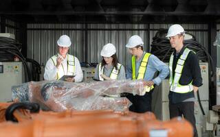 Group of engineers and technicians working together in a robotic arm factory. Inspecting robot arm before delivering to customers photo