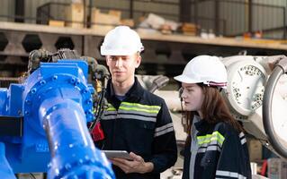 Both of engineers working together in a robotic arm factory, Robotic arm industry and engineering concept. photo