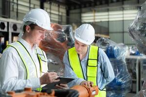 Both of engineers working together in a robotic arm factory, Robotic arm industry and engineering concept. photo