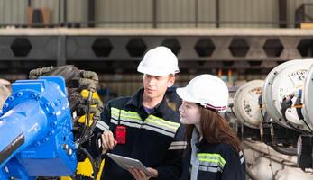 Both of engineers working together in a robotic arm factory, Robotic arm industry and engineering concept. photo