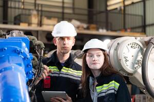 Both of engineers working together in a robotic arm factory, Robotic arm industry and engineering concept. photo