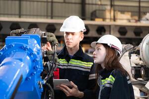 Both of engineers working together in a robotic arm factory, Robotic arm industry and engineering concept. photo