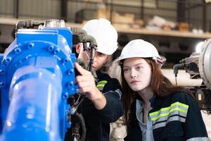 Both of engineers working together in a robotic arm factory, Robotic arm industry and engineering concept. photo