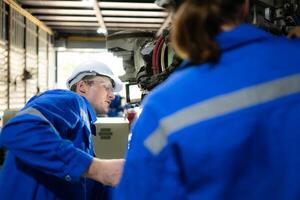 Both of engineers working together in a robotic arm factory, Robotic arm industry and engineering concept. photo