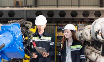 Both of engineers working together in a robotic arm factory, Robotic arm industry and engineering concept. photo