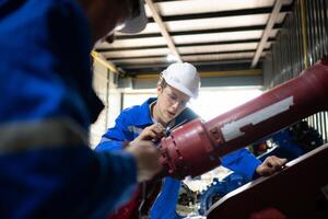 Both of engineers working together in a robotic arm factory, Robotic arm industry and engineering concept. photo