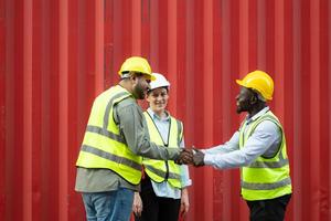 Group of workers in a container storage yard greeting each other during breaks in front of container warehouse, photo