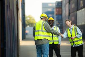 Group of workers in a container storage yard greeting each other during breaks in front of container warehouse, photo