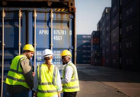 Group of workers in an empty container storage yard, The condition of the old container is being assessed to determine whether it requires maintenance for usage. photo