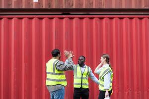 Group of workers in a container storage yard greeting each other during breaks in front of container warehouse, photo