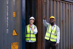 Both of engineers working in the container yard. This is a freight transportation and distribution warehouse. photo