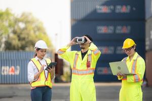 Engineers and laborers utilize VR headsets to control work in a container warehouse. photo