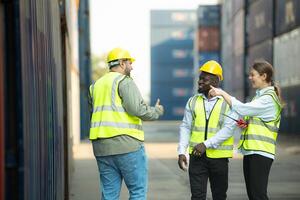 Group of workers in a container storage yard greeting each other during breaks in front of container warehouse, photo