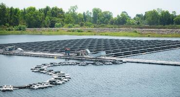 Both of technicians are currently evaluating and repairing the transmission terminals for electricity generated by solar energy in a floating solar power system. photo