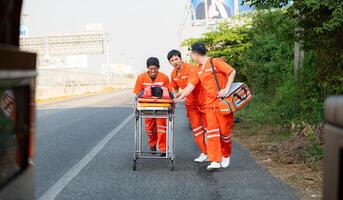 The paramedic  is assisting an injured man in an emergency situation on the road. photo